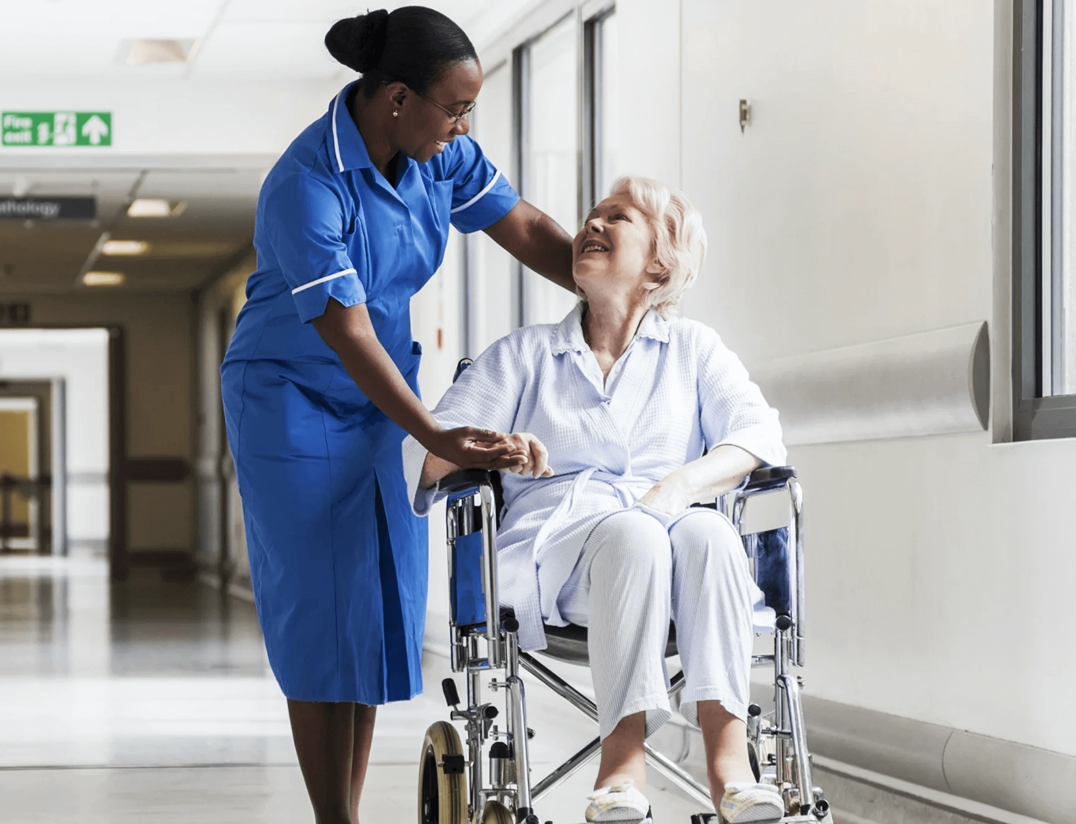nurse with woman in wheelchair - acute care courses, EKG interpretation, PCCN certification