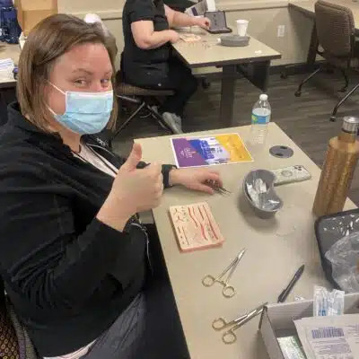 person with mask on giving thumbs up, EKG interpretation, PCCN certification
